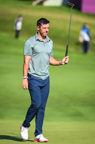 Rory McIlroy of Team Ireland raises his putter to fans on the 18th hole green during the final round of Mens Individual Stroke Play Golf on day nine...