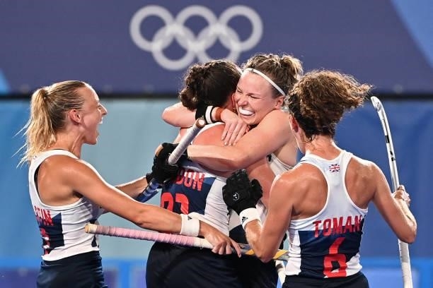 Britain's Hannah Martin, Grace Balsdon, Hollie Pearne-Webb and Anna-Frances Toman celebrate after teammate Fiona Anne Crackles scored the team's...