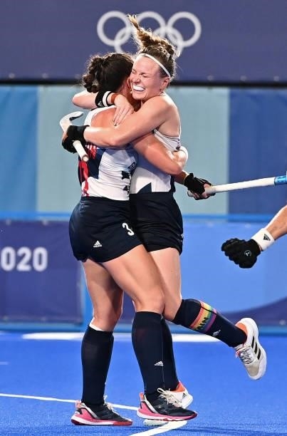 Britain's Grace Balsdon and Hollie Pearne-Webb celebrate after teammate Fiona Anne Crackles scored the team's second goal against Spain during their...