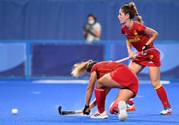 Spain's Maria Lopez strikes the ball next to teammate Carlota Petchame before the team scored against Britain during their women's quarter-final...