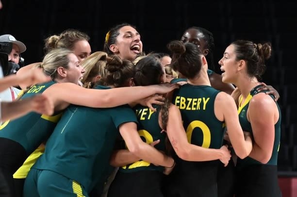 Australia's players celebrate their victory at the end of the women's preliminary round group C basketball match between Australia and Puerto Rico...