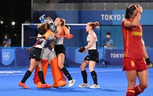 Britain's goalkeeper Madeleine Claire Hinch celebrates with teammates Anna-Frances Toman and Hannah Martin after defeating Spain in the penalty...