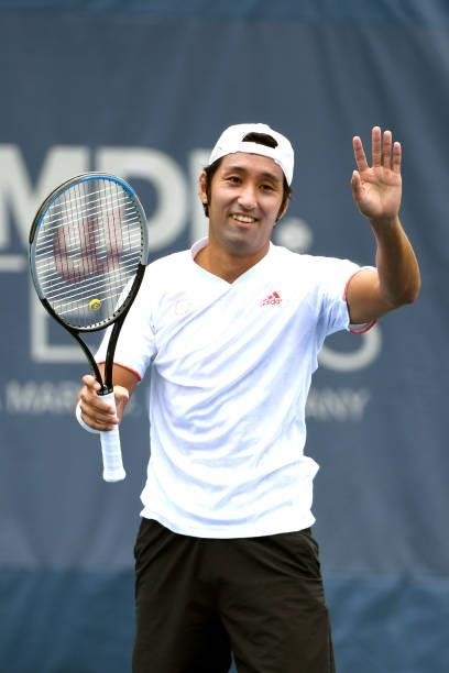 Yasutaka Uchiyama of Japan waves to fans during a match against Andreas Seppi of Italy on Day 3 during the Citi Open at Rock Creek Tennis Center on...