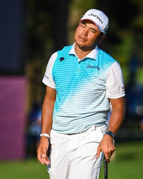 Hideki Matsuyama of Team Japan reacts after missing a par putt on the 18th hole green, eliminating him for a playoff in the final round of Mens...