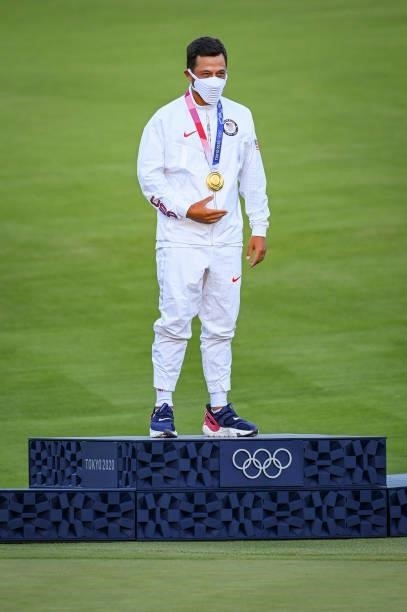 Xander Schauffele of Team USA puts on his gold medal following the final round of Mens Individual Stroke Play Golf on day nine of the Tokyo 2020...