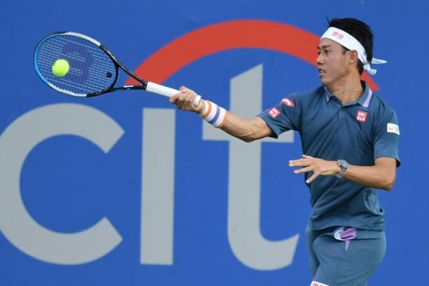 Kei Nishikori of Japan returns a shot against Sam Querrey of the United States on Day 3 during the Citi Open at Rock Creek Tennis Center on August 2,...