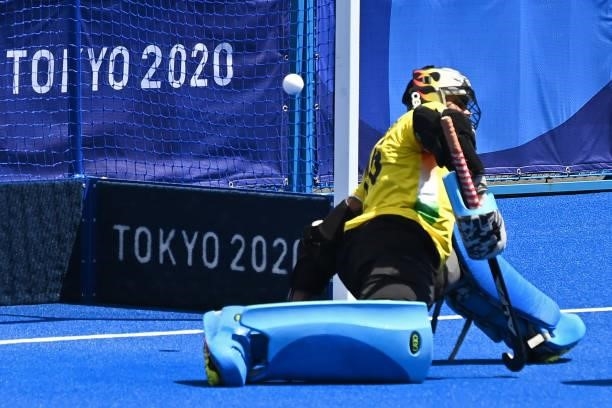 Belgium's goalkeeper Vincent Vanasch dives but the ball shot by Belgium's Loick Fanny Luypaert goes back into the net during their men's semi-final...