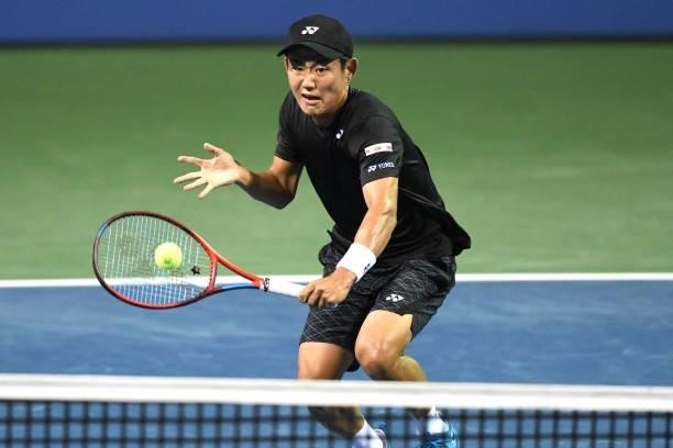 Yoshihito Nishioka of Japan returns a shot against Jack Sock of the United States on Day 3 of the Citi Open at Rock Creek Tennis Center on August 2,...