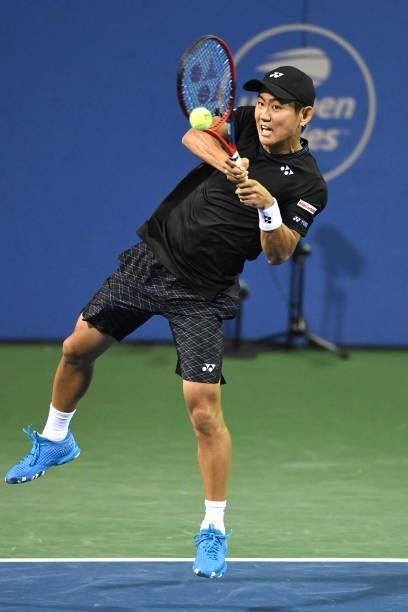 Yoshihito Nishioka of Japan returns a shot against Jack Sock of the United States on Day 3 of the Citi Open at Rock Creek Tennis Center on August 2,...