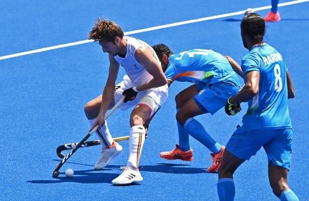 Belgium's Antoine Sylvain Kina is tackled by India's Lalit Kumar Upadhyay during their men's semi-final match of the Tokyo 2020 Olympic Games field...