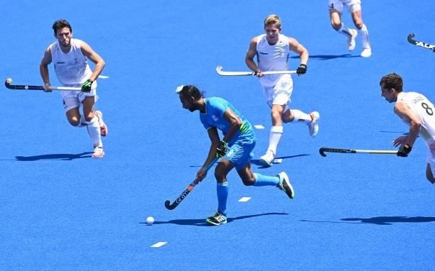 India's Hardik Singh carries the ball during the men's semi-final match of the Tokyo 2020 Olympic Games field hockey competition against Belgium, at...