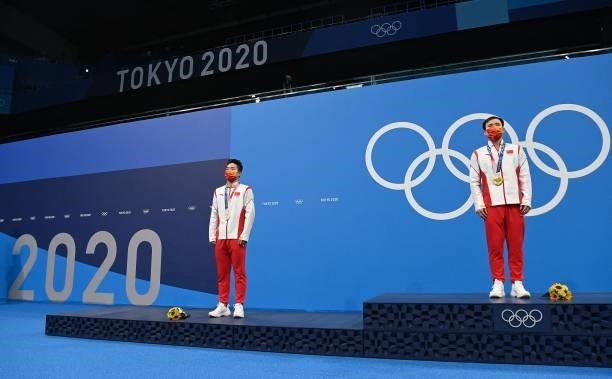 Silver medallist China's Wang Zongyuan and Gold medallist China's Xie Siyi pose with their medals on the podium after the men's 3m springboard diving...