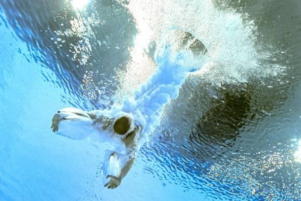 An underwater view shows Russia's Evgenii Kuznetsov after completing his dive in the men's 3m springboard diving final event during the Tokyo 2020...