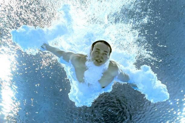 An underwater view shows China's Xie Siyi after completing his dive to win the men's 3m springboard diving final event during the Tokyo 2020 Olympic...