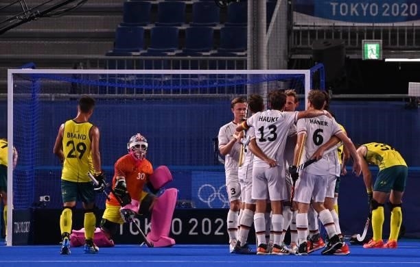 Germany's Lukas Windfeder celebrates with teammates after scoring against Australia during their men's semi-final match of the Tokyo 2020 Olympic...