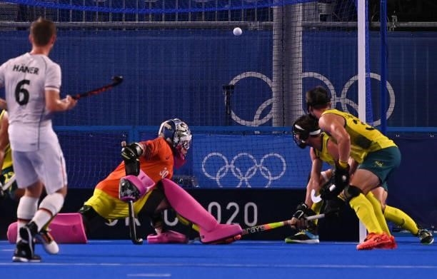 Australia's goalkeeper Andrew Lewis Charter looks at the ball go ito the net es Germany's Lukas Windfeder scores during their men's semi-final match...