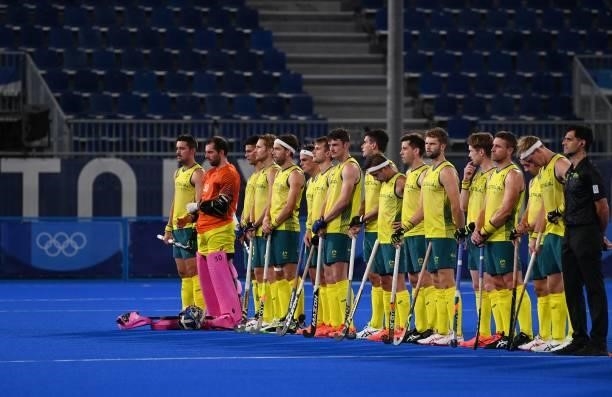 Players of Australia listen to the national anthems before the men's semi-final match of the Tokyo 2020 Olympic Games field hockey competition...
