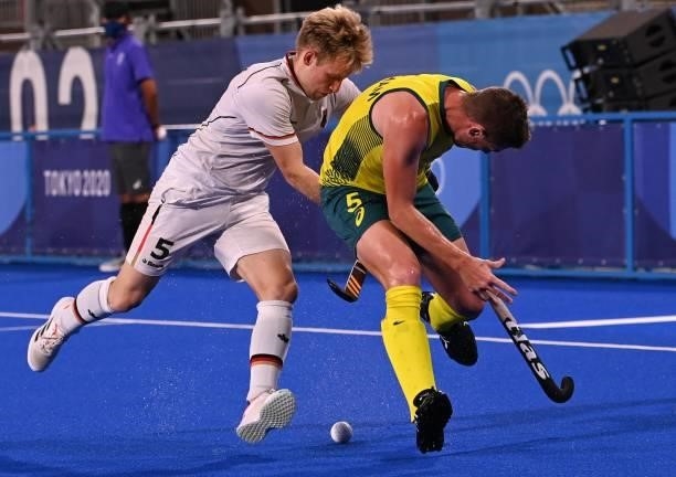 Australia's Tom Joseph Wickham is tackled by Germany's Linus Muller during their men's semi-final match of the Tokyo 2020 Olympic Games field hockey...