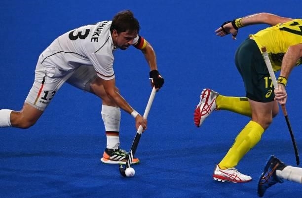 Germany's Tobias Constantin Hauke drives the ball behind Australia's Aran Zalewski during their men's semi-final match of the Tokyo 2020 Olympic...