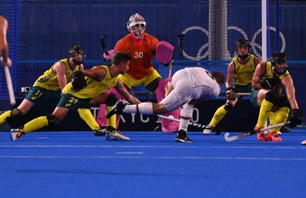 Germany's Martin Dominik Haner strikes the ball as Australia's goalkeeper Andrew Lewis Charter looks on during the men's semi-final match of the...