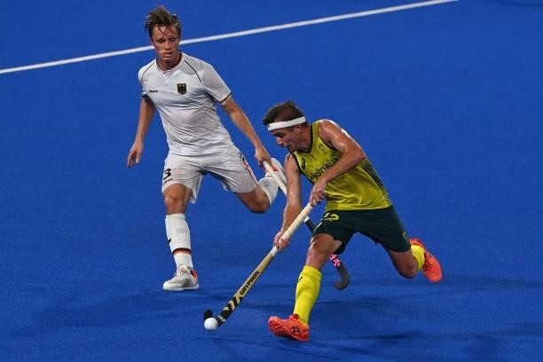 Australia's Jacob Thomas Whetton carries the ball as Germany's Mats Jurgen Grambusch challenges him during their men's semi-final match of the Tokyo...