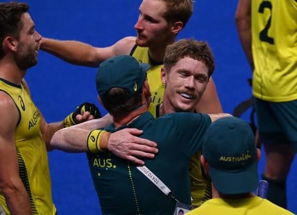 Players of Australia celebrate after defeating Germany 3-1 in their men's semi-final match of the Tokyo 2020 Olympic Games field hockey competition,...