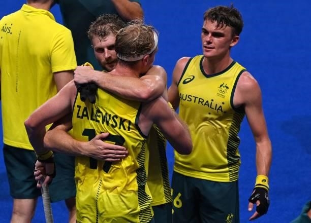 Players of Australia celebrate after defeating Germany 3-1 in their men's semi-final match of the Tokyo 2020 Olympic Games field hockey competition,...