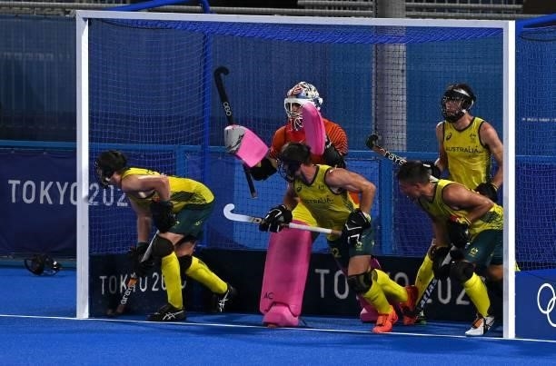 Australia's goalkeeper Andrew Lewis Charter and teammates defend their goal during a penalty corner in favour of Germany during their men's...
