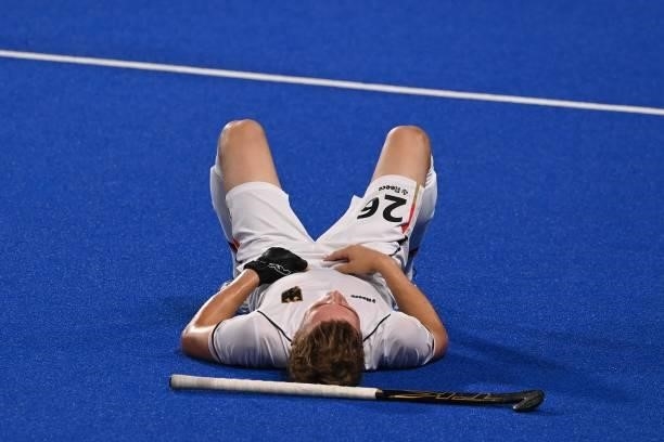Germany's Niklas Bosserhoff lies on the pitch after losing 3-1 to Australia in their men's semi-final match of the Tokyo 2020 Olympic Games field...