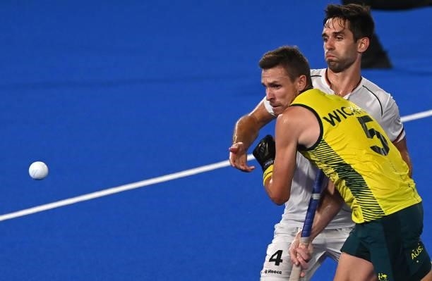 Australia's Tom Joseph Wickham and Germany's Lukas Windfeder vie for the ball during their men's semi-final match of the Tokyo 2020 Olympic Games...