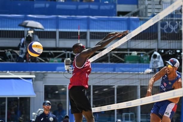 S Nicholas Lucena hits a shot past Qatar's Cherif Younousse in their men's beach volleyball round of 16 match between Qatar and the USA during the...