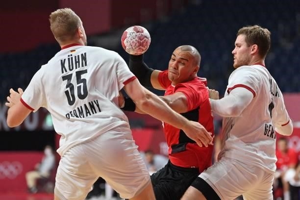 Egypt's pivot Mohamed Mamdouh Shebib is challenged by Germany's pivot Johannes Golla during the men's quarterfinal handball match between Germany and...