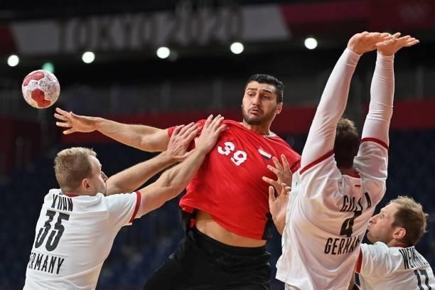 Egypt's left back Yehia Elderaa passes the ball past Germany's right back Steffen Weinhold and teammates during the men's quarterfinal handball match...