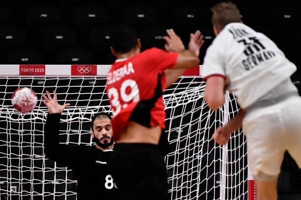 Egypt's goalkeeper Karim Hendawy tries to stop a shot during the men's quarterfinal handball match between Germany and Egypt of the Tokyo 2020...