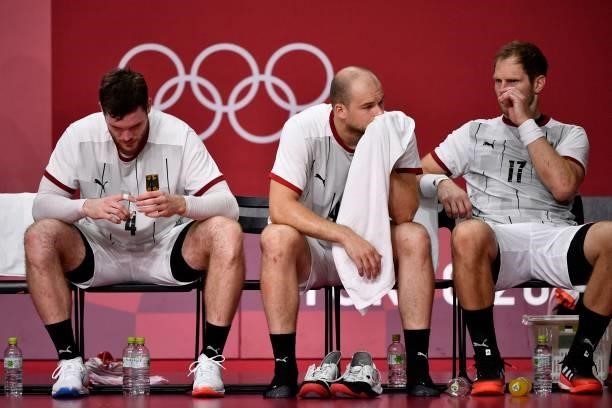 Germany's pivot Johannes Golla, Germany's left back Paul Drux and Germany's right back Steffen Weinhold react after being defeated by Egypt at the...