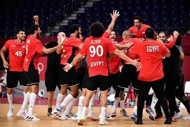 Egypt's players celebrate their victory after the men's quarterfinal handball match between Germany and Egypt of the Tokyo 2020 Olympic Games at the...