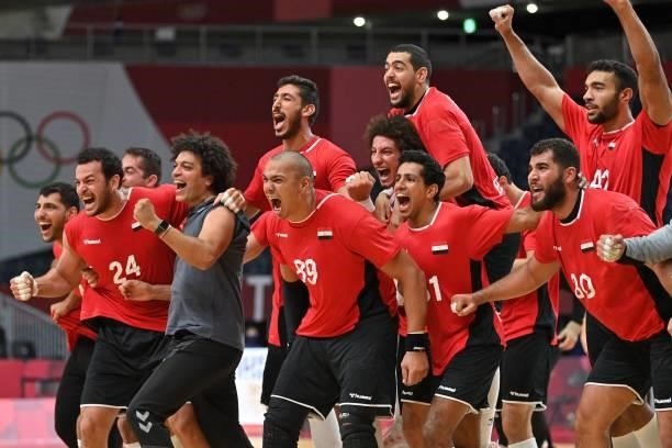 Egypt's players celebrate their victory after the men's quarterfinal handball match between Germany and Egypt of the Tokyo 2020 Olympic Games at the...