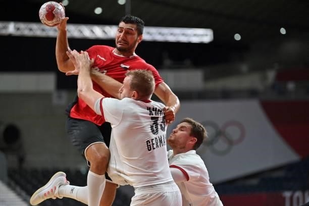 Egypt's left back Yehia Elderaa is challenged by Germany's left back Julius Kuhn during the men's quarterfinal handball match between Germany and...