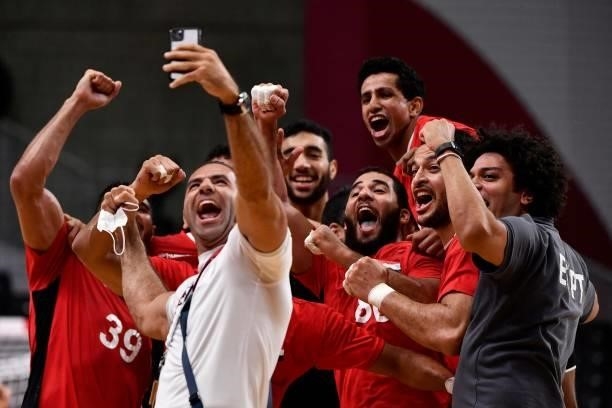 Egypt's players pose for a selfie as they celebrate their victory after the men's quarterfinal handball match between Germany and Egypt of the Tokyo...