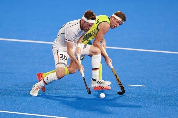 Martin Detlef Zwicker of Team Germany and Jacob Thomas Whetton of Team Australia battle for the ball during the Men's Semifinal match between...