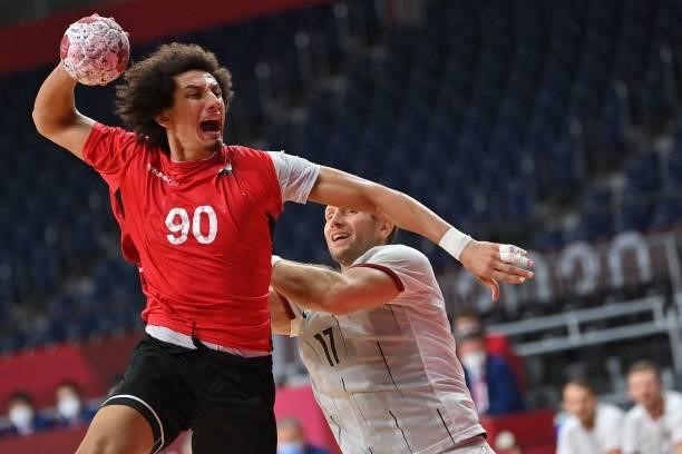 Egypt's left back Ali Mohamed is challenged by Germany's right back Steffen Weinhold as he shootsduring the men's quarterfinal handball match between...