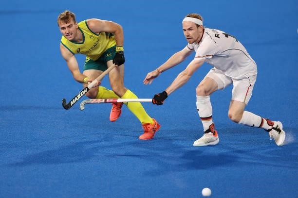 Joshua Simmonds of Team Australia and Jan Christopher Ruhr of Team Germany battle for the ball during the Men's Semifinal match between Australia and...