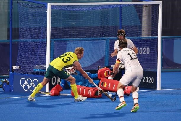 Daniel James Beale of Team Australia vies for the ball with Germany's goalkeeper Alexander Stadler during the Men's Semifinal match between Australia...
