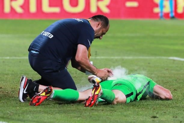 The goalkpeeper of CFR Cluj Giedrius Arlauskis is injured during the UEFA Champions League Third Qualifying Round Leg One match between CFR Cluj and...