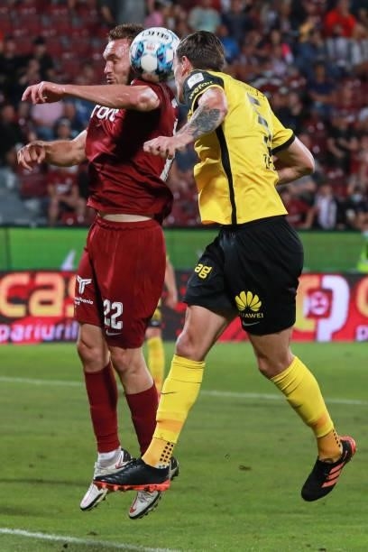 Gabriel Debeljuh jumps for the ball with Cédric Zesiger of Young Boys during the UEFA Champions League Third Qualifying Round Leg One match between...