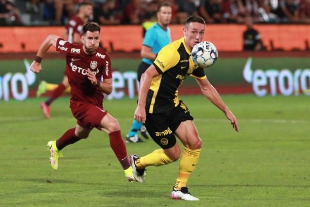 Jordan Siebatcheu of Young Boys and Constantin Paun of CFR Cluj run after the ball during the UEFA Champions League Third Qualifying Round Leg One...