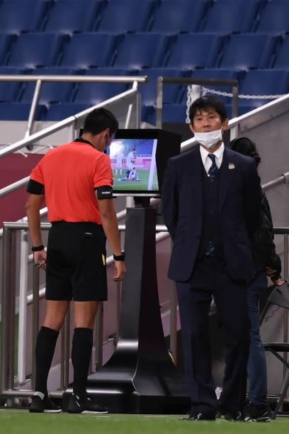 Referee examines the VAR screen for the foul of Maya Yoshida, captain of Japan at Saitama Stadium on August 3, 2021 in Saitama, Japan.