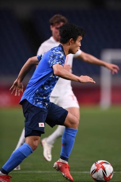 Takefusa Kubo of Japan dribbles the ball at Saitama Stadium on August 3, 2021 in Saitama, Japan.
