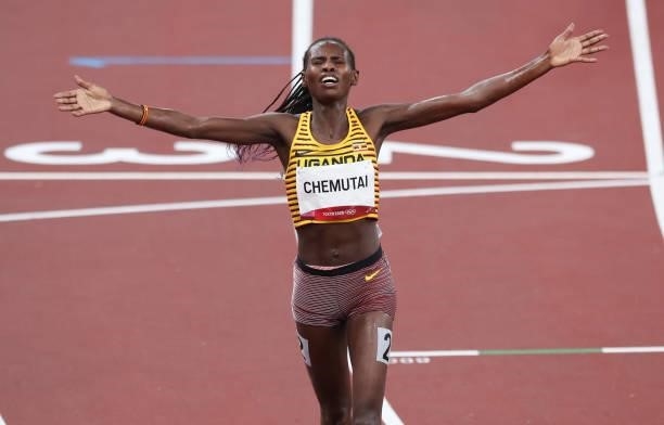 August 2021, Japan, Tokio: Athletics: Olympics, 3000m steeplechase, women, at the Olympic Stadium. Peruth Chemutai from Uganda cheers at the finish....