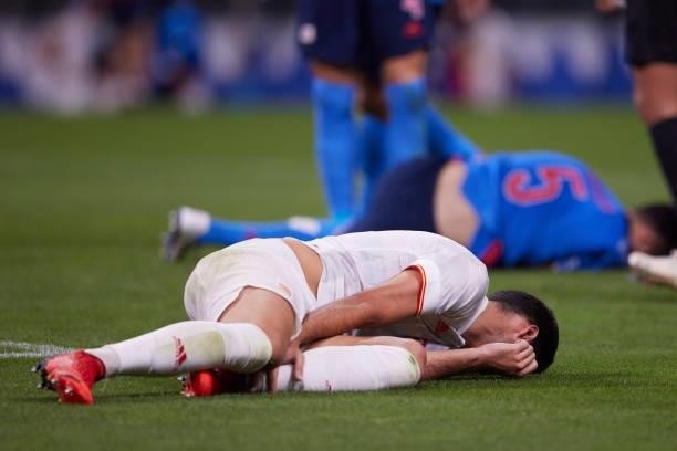 Mikel Merino of Spain lies injured on the pitch during during the Men's Football Semi-final Match between Japan and Spain at Saitama Stadium on...